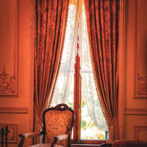 Vintage interior showcasing Ottoman-style decor with elegant drapes and antique furniture.